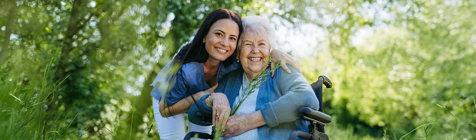 GettyImages-2166715753-hero Resident and care giver outside